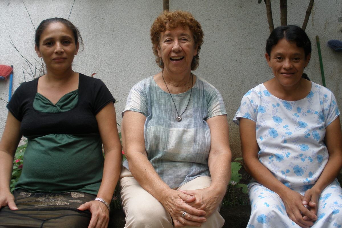 Photograph of Kitty Madden with two pregnant women on either side of her.