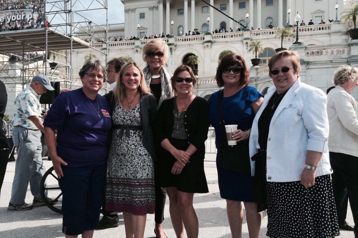 Photograph of Sister Robbie with other women in front of the Captiol building.