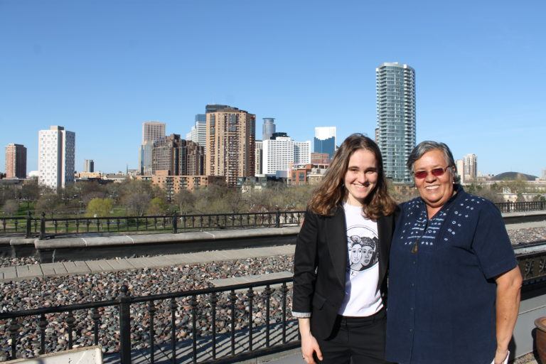 Photograph of Svitlana with Gilda with the Minneapolis Skyline in the background.