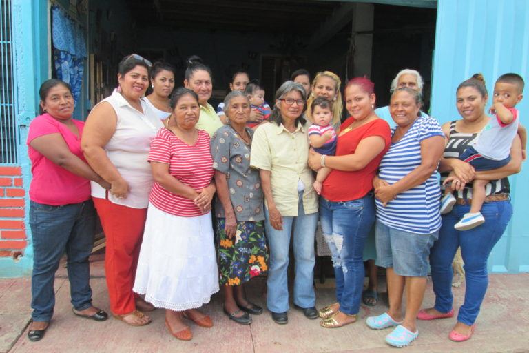 Photograph of a group of women, some with children.