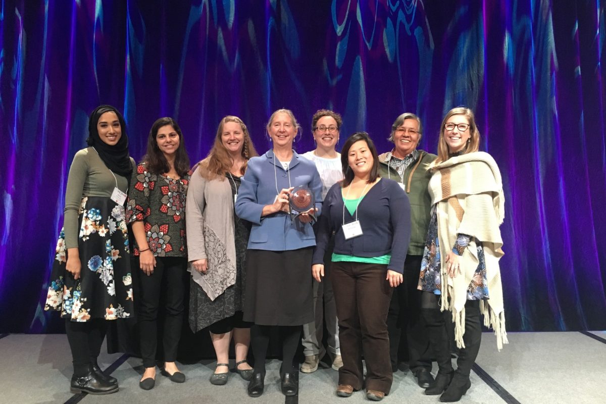 Mary's Pence board and staff on stage with the award for Responsive Philanthropy.