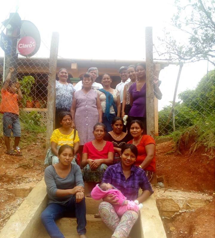 Photograph of all the women of Virignia community, one woman holds a baby.