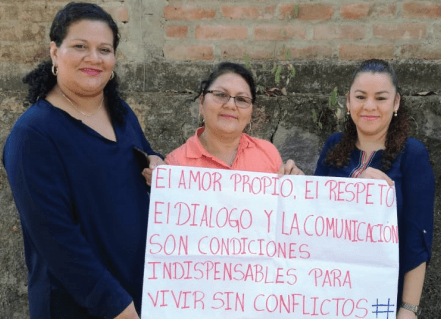 Dora Alicia, center, is participating in ESPERA’s online course. She is pictured with her colleagues Rubidia (left) and Jacqueline (right) showing their hashtag message assignment, which reads: “Self love, respect, dialogue, and communication are indispensable conditions for living without conflicts.”