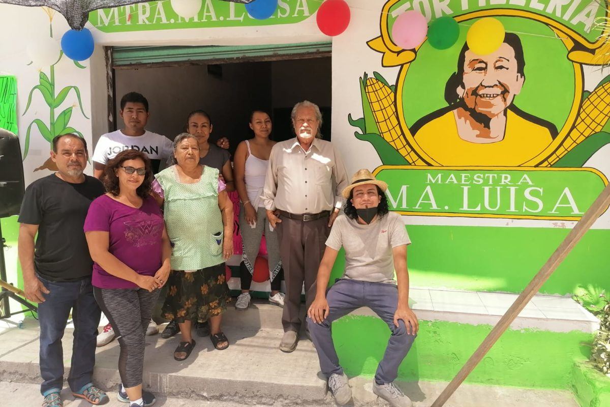 Friends and family sitting outside Tortilleria Maria Luis