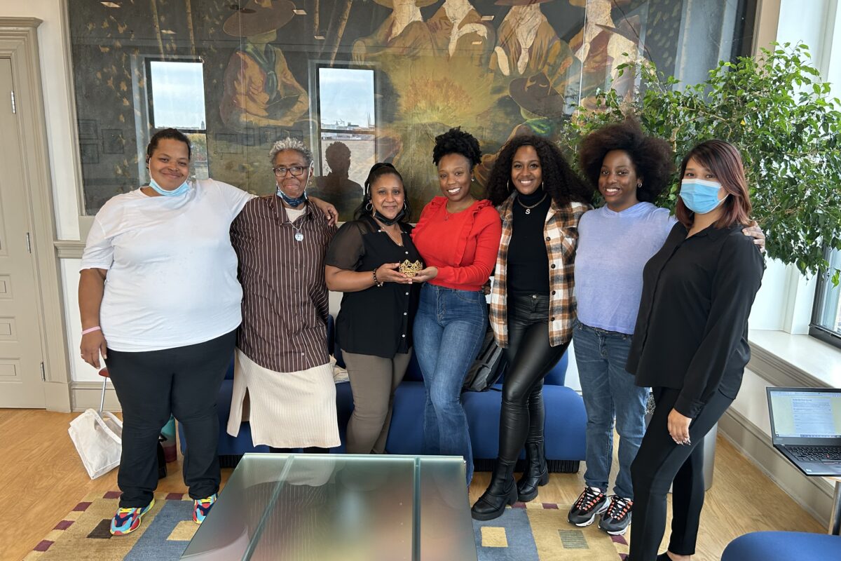 Group of 7 women of color, posing standing and smiling. Embracing second chances means advocating for oneself and working towards healing.